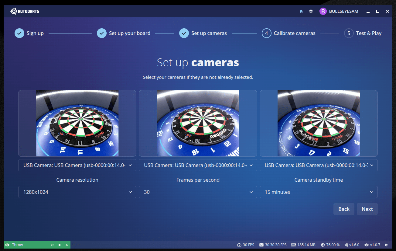 Set up cameras step with three live camera feeds of a dartboard, each with a camera selector, plus resolution/FPS/standby-time settings